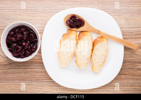 Slices of baguette with cherry jam Stock Photo