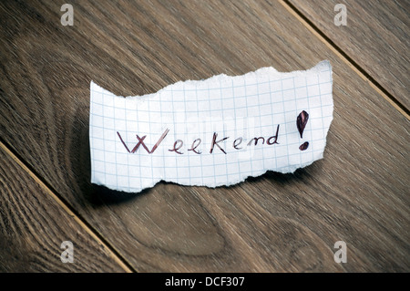 Weekend - Hand writing text on a piece of paper on wood background Stock Photo