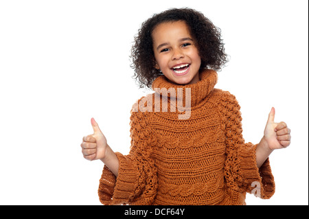 Pretty kid laughing and showing double thumbs up gesture to camera. Stock Photo