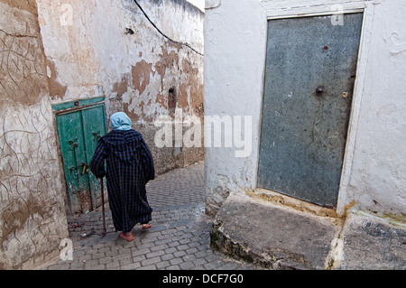 Woman walking on the streets of Moulay Idriss medina. Morocco Stock Photo