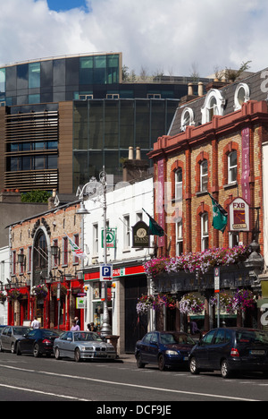 Shops and Pubs on Pargate Street, dwarfed by the new Criminal Courts of Justice, Near the Phoenix Park, Dublin City, Ireland Stock Photo