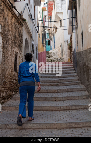 Girl walking on the streets of Moulay Idriss medina, Morocco Stock Photo