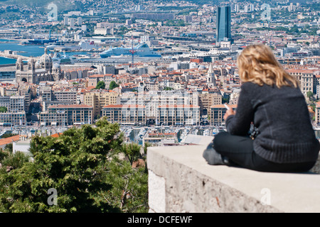 A tourist woman admire  a panorama of the old Marseille, France Stock Photo