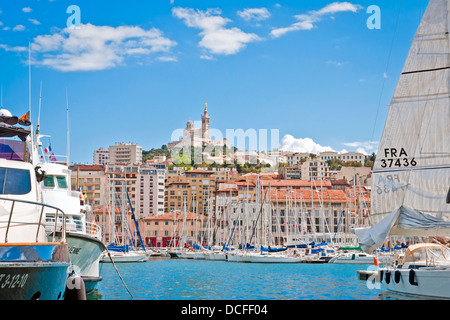 Panorama of the old port with a view of Catholic basilica Notre-Dame de la Garde, Our Lady of the Guard, Marseille, France Stock Photo