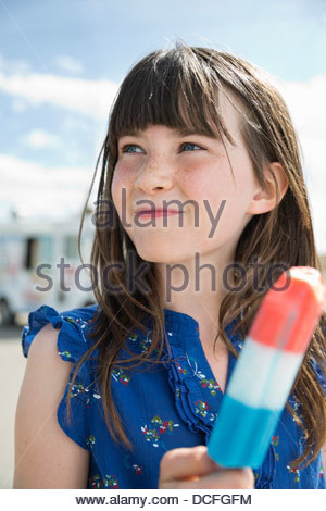 Close-up of little girl holding popsicle