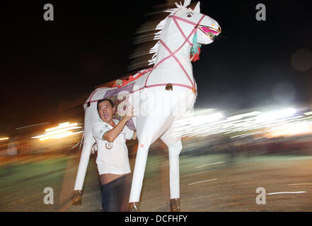 Kajang, SELANGOR, MALAYSIA. 17th Aug, 2013. Kajang, SELANGOR, MALAYSIA. 16th Aug, 2013. A man carries a paper-made horse during the festive event of Hungry Ghost in Kajang, Malaysia. In Chinese tradition the seventh month of the lunar year is regarded as the Ghost Month in which spirits and ghosts come down to earth. During this festival the devotees burn paper-made models to appease the wandering spirits and offers prayers Credit:  Kamal Sellehuddin/ZUMAPRESS.com/Alamy Live News Stock Photo