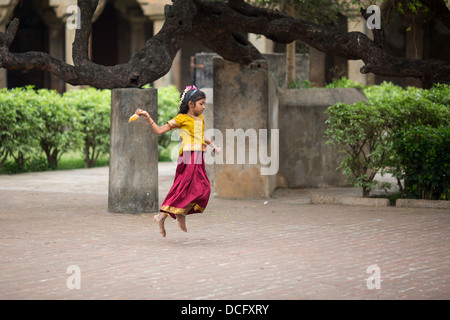 Little Indian girl jumping on the run Stock Photo