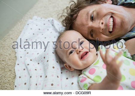 Portrait of father and baby girl smiling