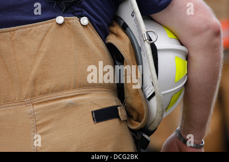 A firefighter holding his white helmet under his arm Stock Photo