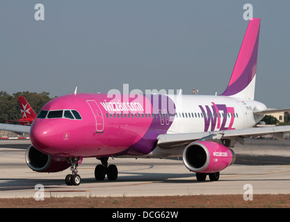 Airbus A320 jet plane belonging to the Hungarian low cost airline Wizz Air taxiing for departure from Malta Stock Photo