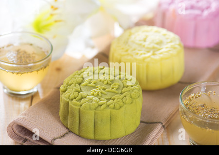 Traditional Chinese mid autumn festival food. Snowy skin mooncakes. The Chinese words on the mooncakes is green tea with red bean paste, noble delight and lotus paste, not a logo or trademark. Stock Photo
