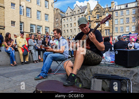 Two men playing guitars in Grassmarket, Edinburgh during the Edinburgh Fringe festival, Edinburgh, Scotland, Great Britain Stock Photo