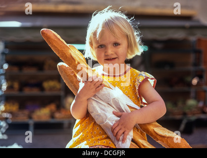 Young girl holding French Baguettes, France Stock Photo
