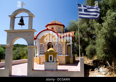Small Chapel with bell tower and Greek flag, Katomeri, Meganisi island, lLefkas, Ionian Islands, Greece. Stock Photo