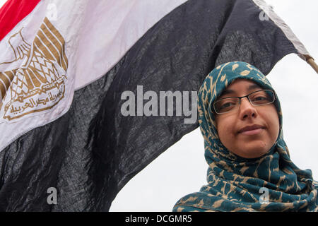 London, UK. 17th Aug, 2013.  A protester with her Egyptian flag as over 100 British Egyptians hold a drive-by protest  on the streets of London against the military coup and subsequent violence in Egypt Credit:  Paul Davey/Alamy Live News Stock Photo
