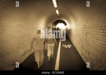 Motion blur people walking pass door of old building in rush hour  representing urban life Stock Photo - Alamy