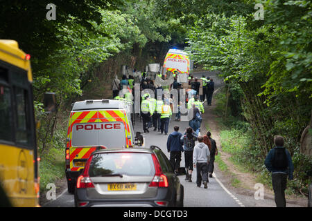 Balcombe, West Sussex, UK. 17th Aug, 2013. Protesters against Cuadrilla drilling & fracking just outside the village of Balcombe are escorted by police towards the protest site on the London Road. Credit:  martyn wheatley/Alamy Live News Stock Photo