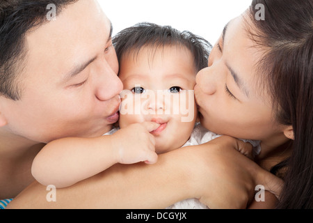 Happy family kissing the baby Stock Photo