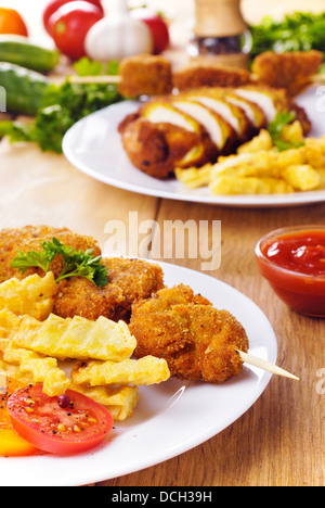 Tasty fried chicken kebab on the white plate on the wooden table Stock Photo