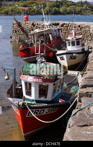 Small red and white fishing boats moored at Broadford Pier, Broadford, Isle of Skye, Scotland, UK