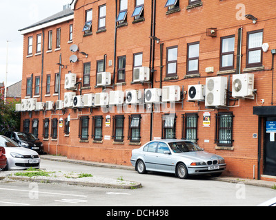 Air conditioning units on side of office building in Manchester UK Stock Photo