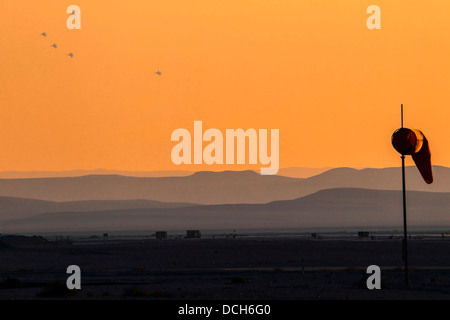 a squadron of Israeli Air force (IAF) Fighter jet F-15 (BAZ) in flight as seen from the airfield at dusk Stock Photo