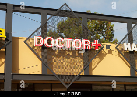 A doctors office sign with red cross in Santa Ana Southern California USA Stock Photo