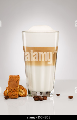 latte macchiato with coffee beans and cantuccini cookies on gray background Stock Photo