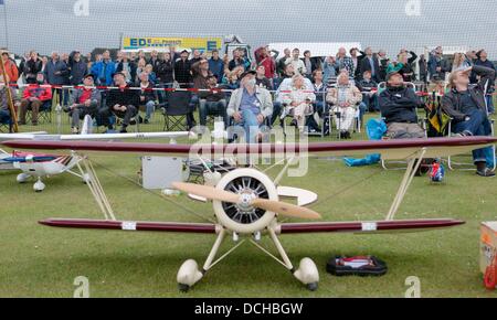 Visitors of the 42nd International RC Aircraft Days follow a demonstration behind a model airplane in Jerrishoe, Germany, 18 August 2013. Around 200 participants from Germany and Scandinavia presented their model planes in competitions and demonstrations. Photo: MARKUS SCHOLZ Stock Photo