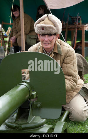 Russian soldiers, military reenactor in Lytham, Blackpool. Jackie Foggin from Newcastle with a Maxim-Tokarev machine gun (Russia / USSR), a re-enactor wearing the costume of a Russian Soldier at Lytham 1940's Wartime Festival held on Lytham Green, Lancashire, UK. Stock Photo