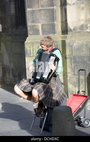 Accordionist busking outside St. Giles' Kirk, Edinburgh. Stock Photo