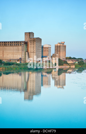 Old granaries for storing wheat and other cereal grains near the river Stock Photo