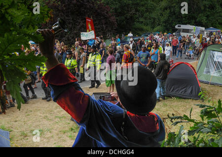 Balcombe, West Sussex, UK. 18th Aug, 2013. Balcombe, West Sussex, UK. 18th Aug, 2013. More protesters arrive to join the locals on the road to Cuadrilla drill site at Balcombe cheered on by this colorful bell ringer. © David Burr/Alamy Live News Stock Photo