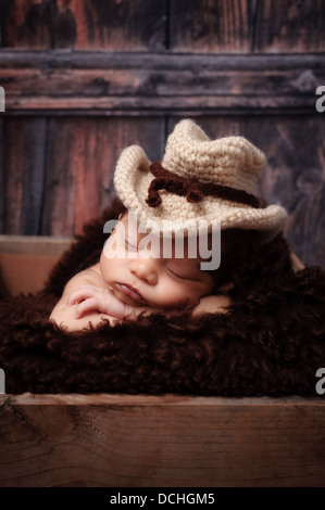 Newborn Baby Boy Wearing a Cowboy Hat Stock Photo