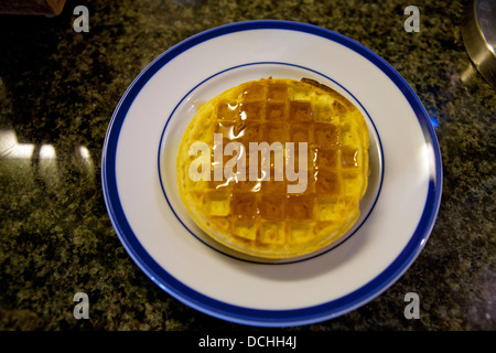 Two Kellog's Eggo breakfast waffles on a plate with maple syrup Stock Photo