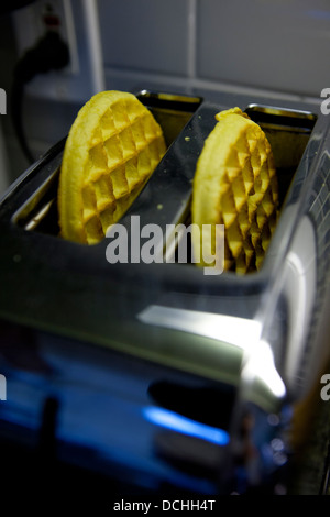 Two Kellog's Eggo breakfast waffles in a toaster Stock Photo