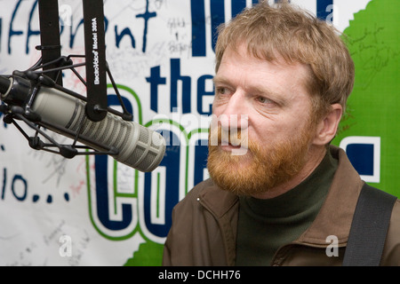 Recording artist David Lowery of the band Cracker talks into a microphone in a radio studio on March 2, 2007 in Charlottesville, VA. Stock Photo