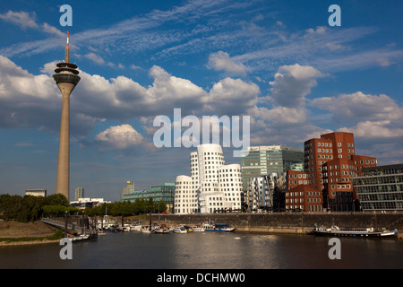 The 'Dancing Buildings' by Frank O Gehry at Medienhafen with the Rheinturm tower at back, Düsseldorf Stock Photo
