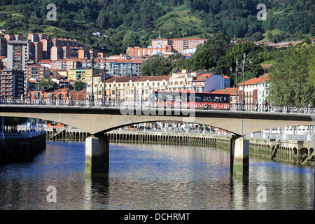 Bus driving over a bridge spanning the Nervion River in Bilbao, Spain Stock Photo