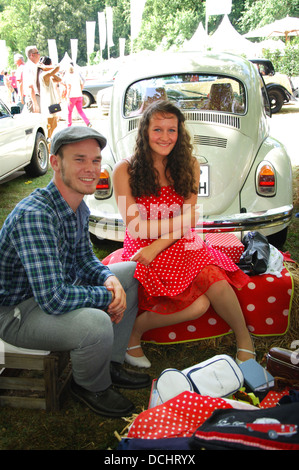 period style couple and their VW beetle at Clsssic Days 2013 Schloss Dyck Germany Stock Photo