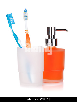 Two colorful toothbrushes and liquid soap. Isolated on white background Stock Photo