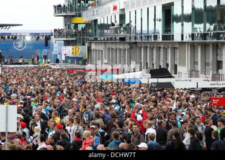 Nuerburg, Germany. 18th Aug, 2013. The pit lane is crowded during a pit walk at the German Touring Car Masters (DTM) qualification at the Nuerburgring racing curcuit near Nuerburg, Germany, 18 August 2013. Photo: Thomas Frey/dpa/Alamy Live News Stock Photo