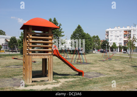 Children's school playground with swings and slide the red Stock Photo