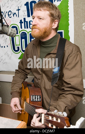 Recording artist David Lowery of the band Cracker performs with his guitar in a radio studio on March 2, 2007 in Charlottesville, VA. Stock Photo