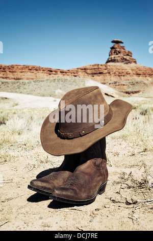 Boots and hat in front of Mexican Hat, USA Stock Photo
