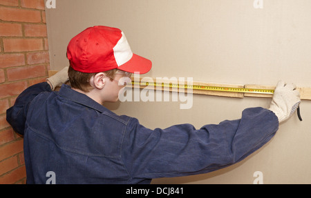 The worker measures wooden panel Stock Photo