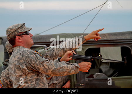 U.S. Army Staff Sgt. James Nirenberg, a Raven master instructor from the Florida Army National Guard, trains soldiers from the New Jersey Army National Guard on a RQ-11B Raven radio tracking system at Castles Drop Zone, Fort Pickett, Va., on Aug. 16. Stock Photo