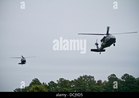 Two U.S. Army UH-60 Black Hawk helicopters from the 1-150 Assault Helicopter Battalion, New Jersey Army National Guard, transport soldiers and airmen during an air insertion exercise at Fort Pickett, Va., on Aug 17. Stock Photo