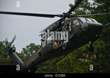 A U.S. Army UH-60 Black Hawk helicopter from the 1-150 Assault Helicopter Battalion, New Jersey Army National Guard, transports Stock Photo