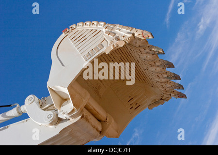 Open pit gold mining in Mauritania. Close up of giant excavator bucket about to mine ore. West Africa Stock Photo